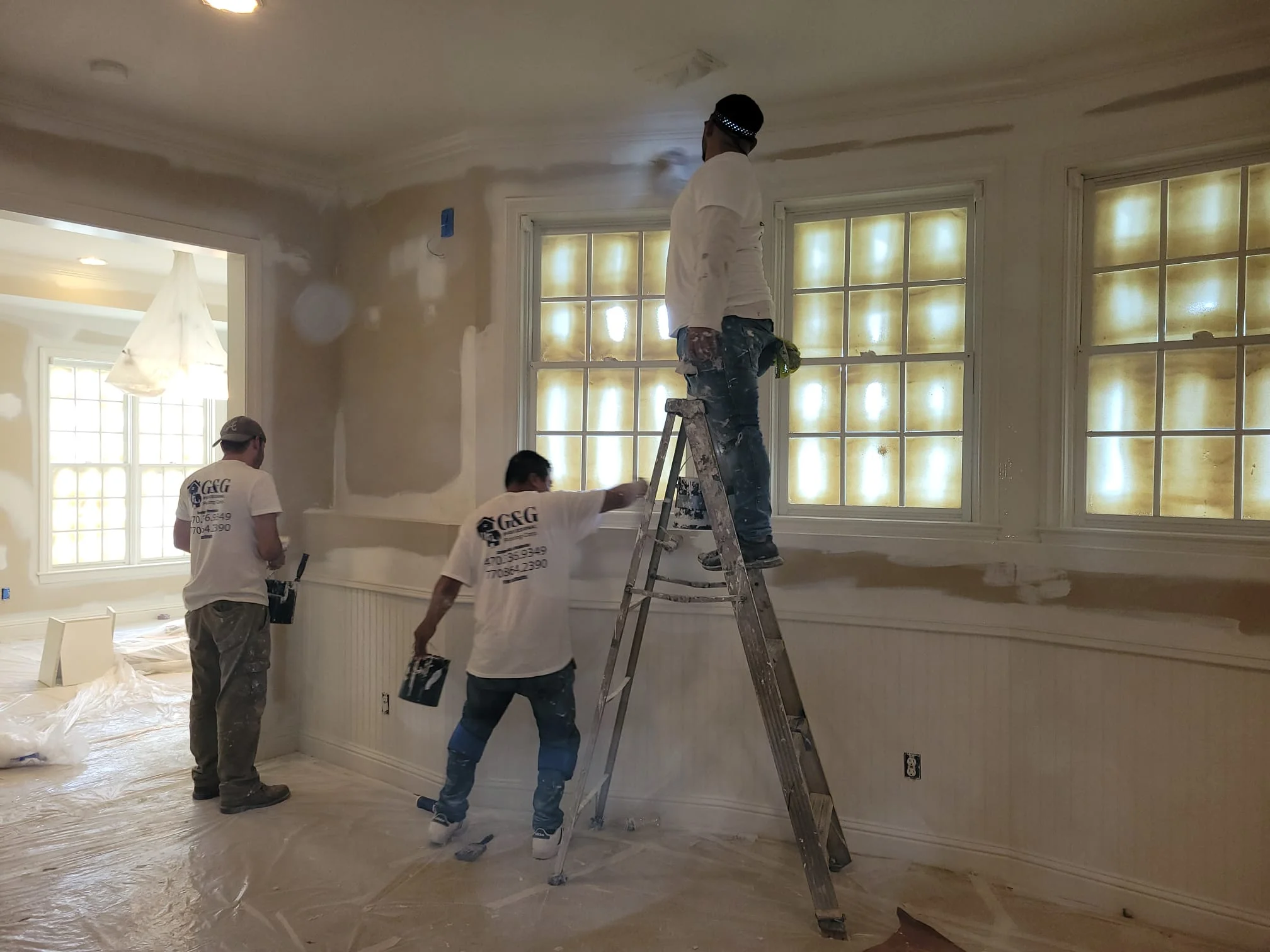 G&G painters prepping and painting a living room interior in Atlanta, GA