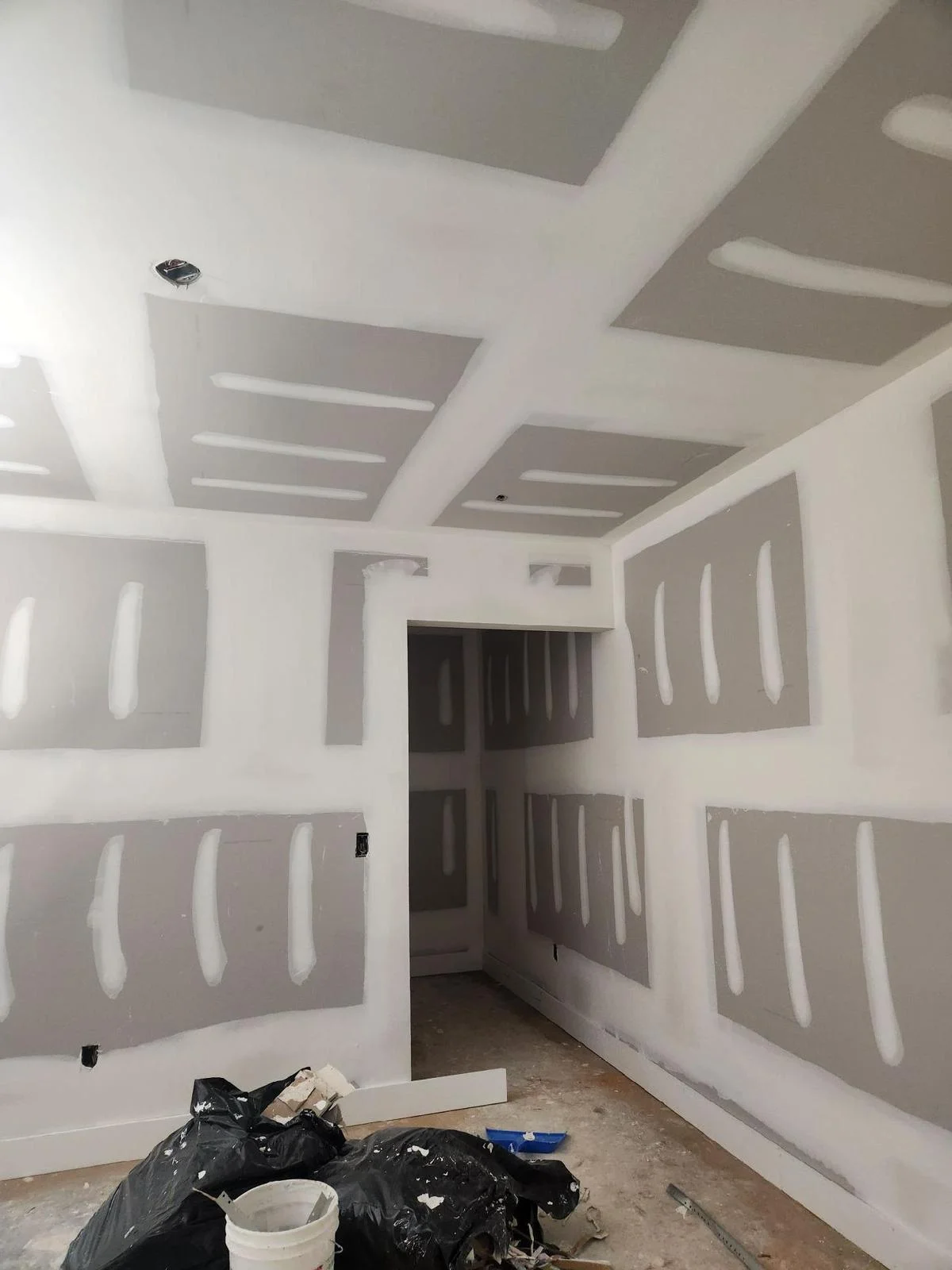 Drywall patching and finishing in progress before painting